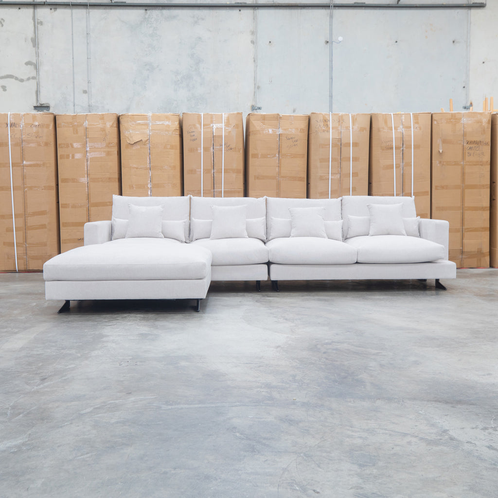 The Melbourne Deep Seat Feather & Foam Modular Corner Lounge - Biscuit available to purchase from Warehouse Furniture Clearance at our next sale event.