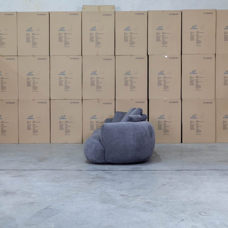The Maven Curved Fabric Four Seat Sofa - Charcoal available to purchase from Warehouse Furniture Clearance at our next sale event.