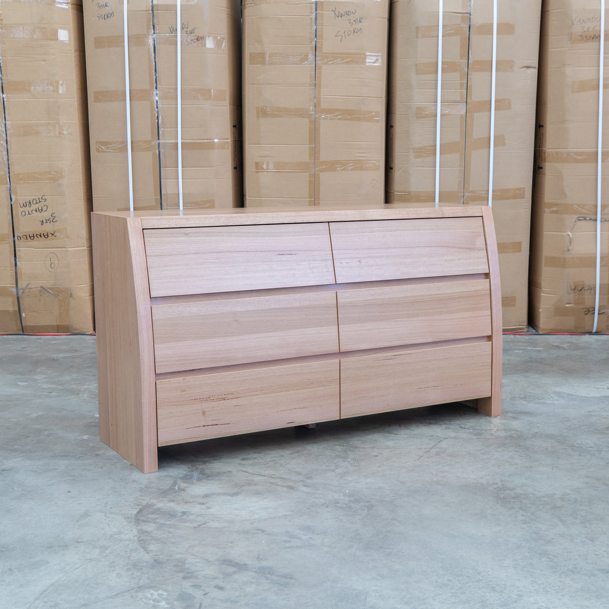 The Melba Curved Australian Messmate Six Drawer Dresser available to purchase from Warehouse Furniture Clearance at our next sale event.