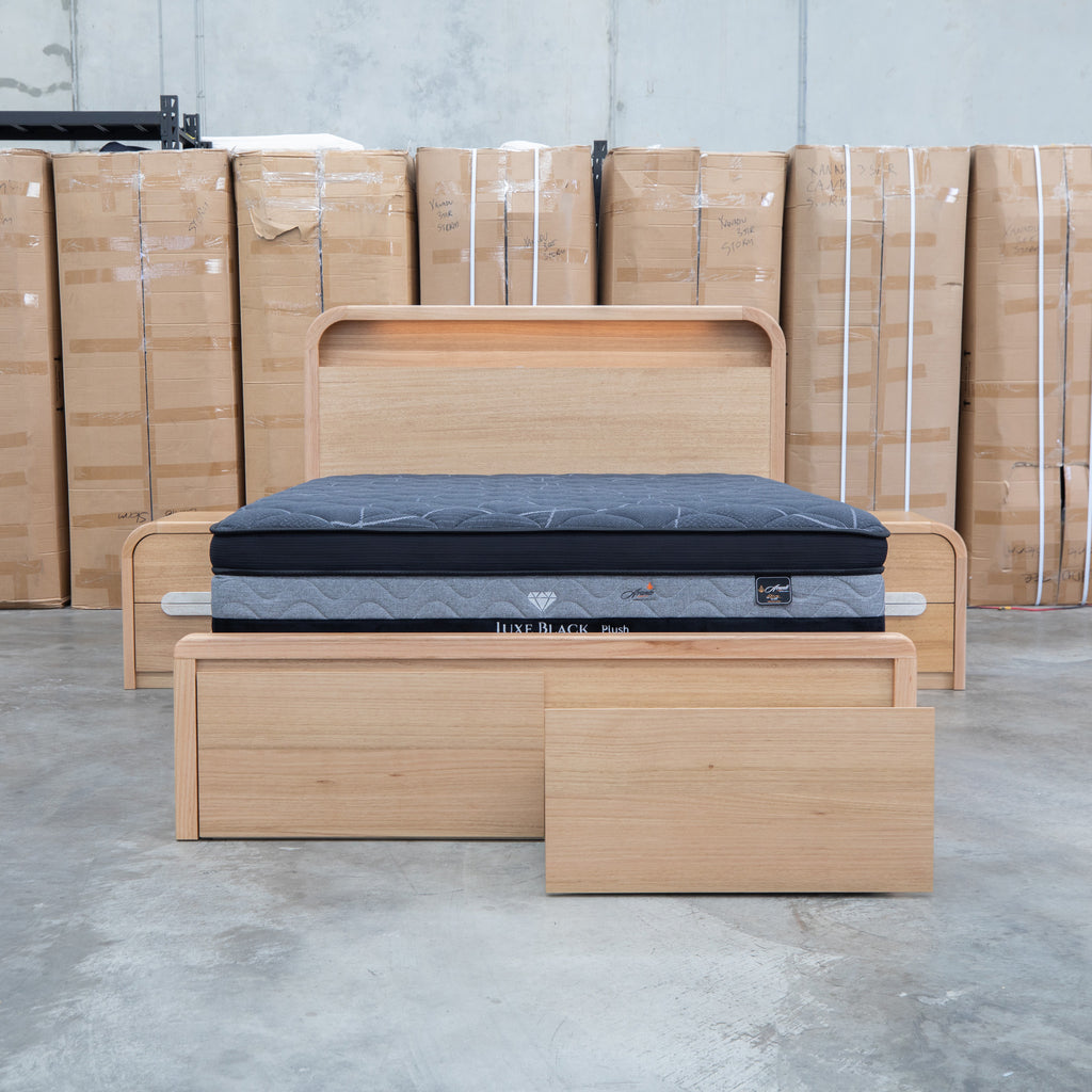 The Hastings Tasmanian Oak Queen Gaslift Bed with Storage Drawers available to purchase from Warehouse Furniture Clearance at our next sale event.