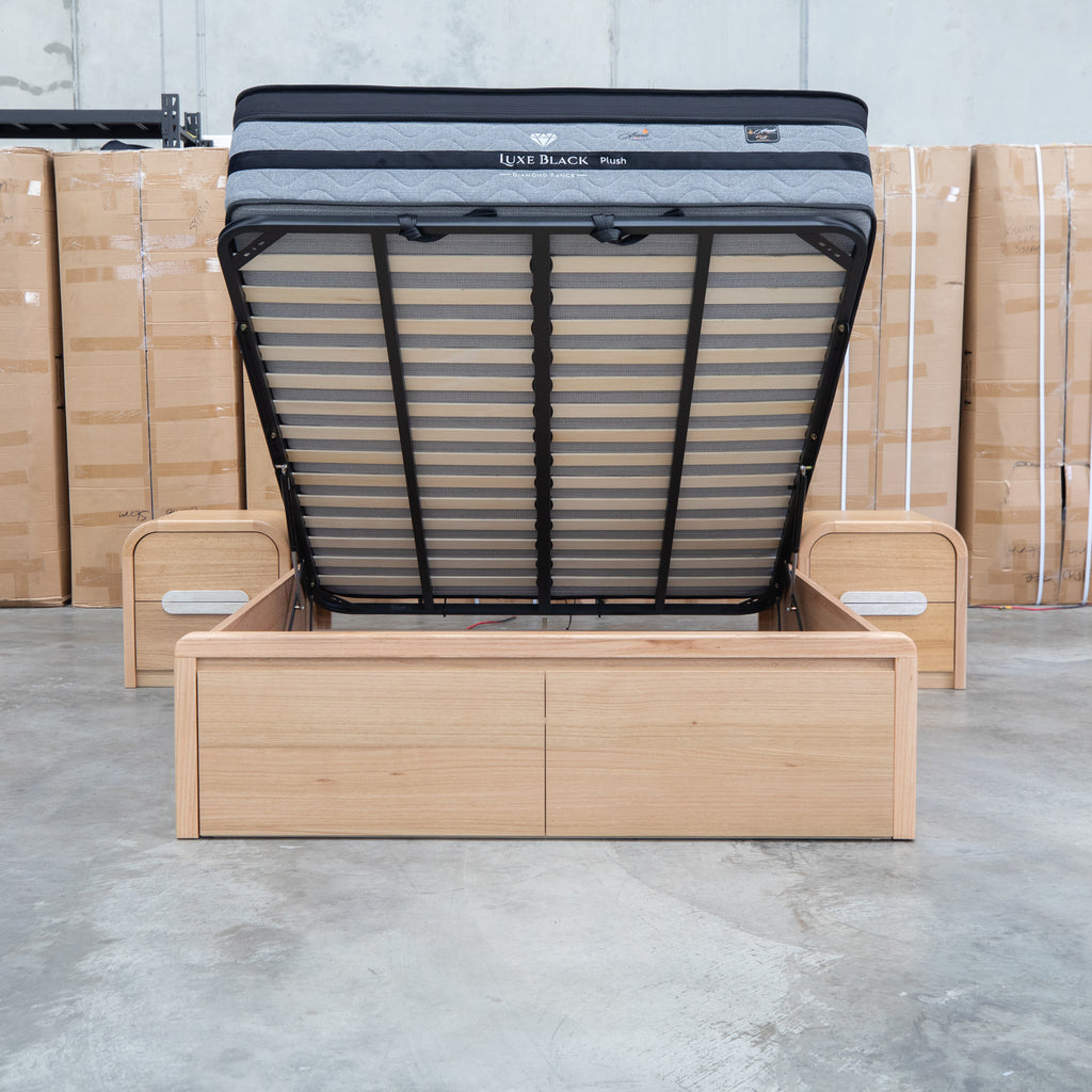 The Hastings Tasmanian Oak Queen Gaslift Bed with Storage Drawers available to purchase from Warehouse Furniture Clearance at our next sale event.