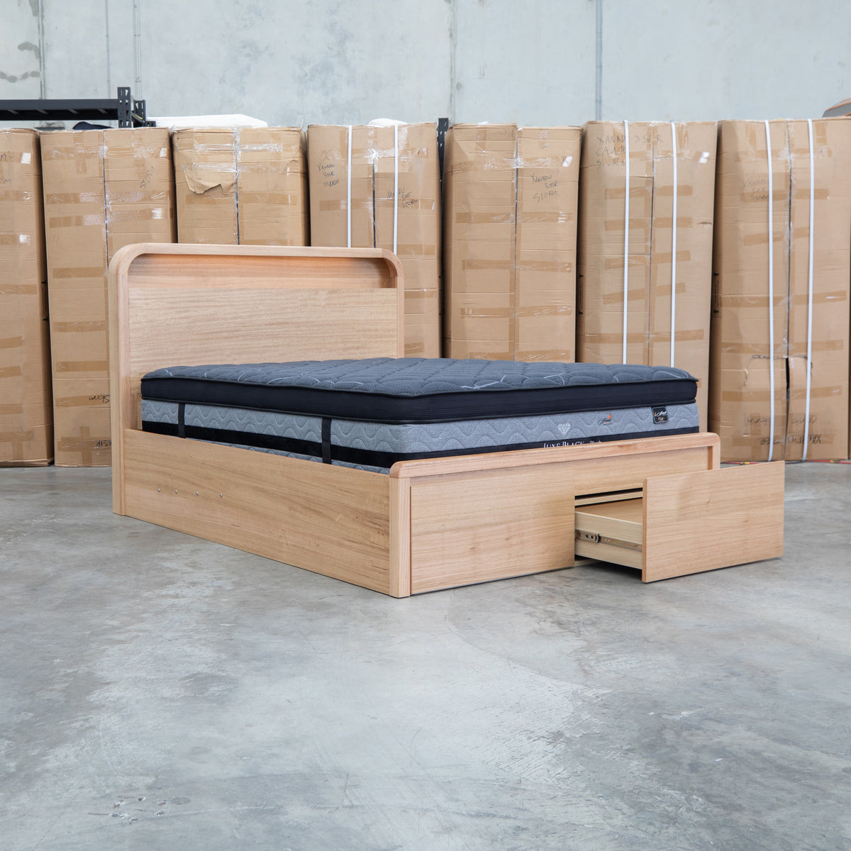 The Hastings Tasmanian Oak Queen Gaslift Bed with Storage Drawers available to purchase from Warehouse Furniture Clearance at our next sale event.