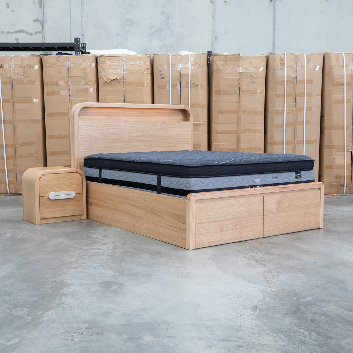 The Hastings Tasmanian Oak Queen Gaslift Bed with Storage Drawers available to purchase from Warehouse Furniture Clearance at our next sale event.
