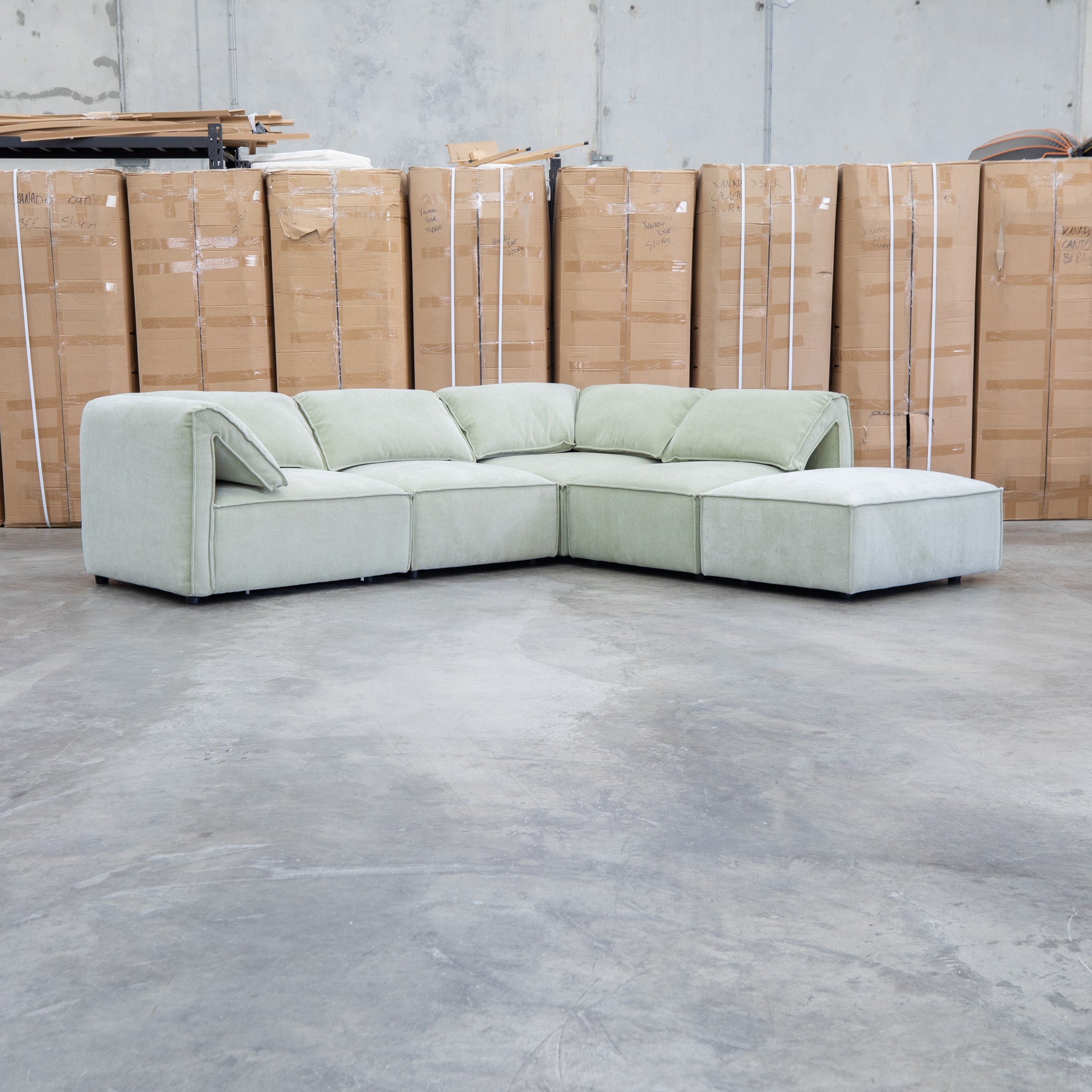 The Sienna Feather & Foam Modular Corner Lounge with Ottoman - Pistachio available to purchase from Warehouse Furniture Clearance at our next sale event.