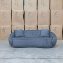 The Noosa Curved Fabric Three Seat Sofa - Dark Grey available to purchase from Warehouse Furniture Clearance at our next sale event.