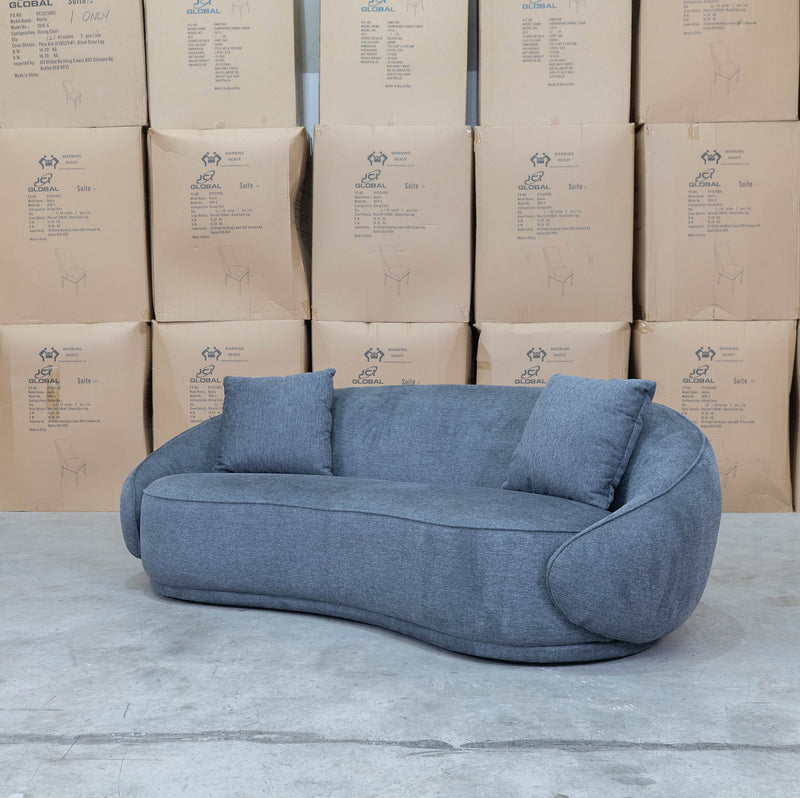 The Noosa Curved Fabric Three Seat Sofa - Dark Grey available to purchase from Warehouse Furniture Clearance at our next sale event.
