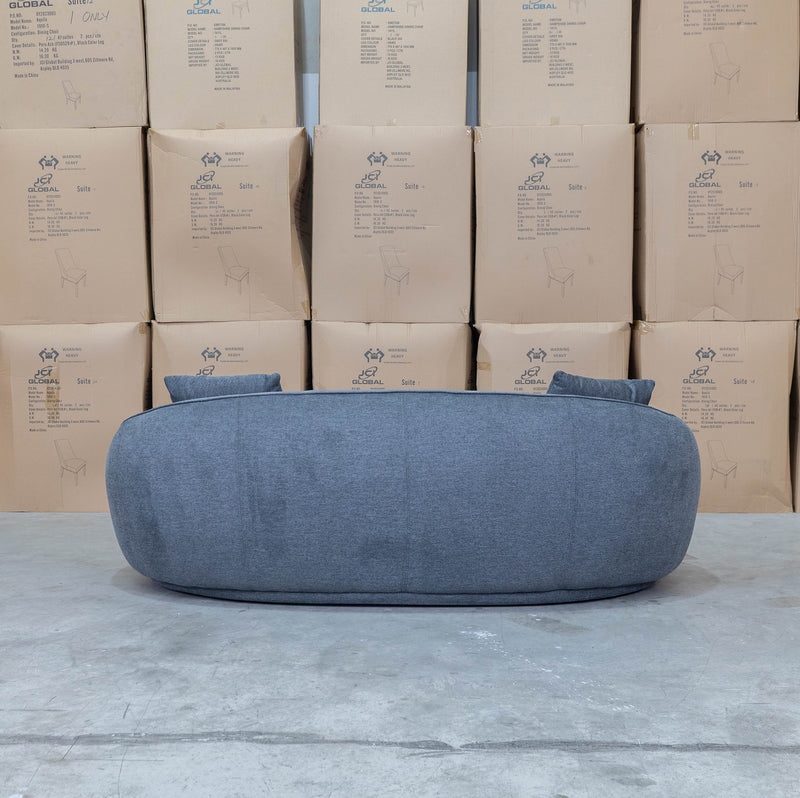 The Noosa Curved Fabric Three Seat Sofa - Dark Grey available to purchase from Warehouse Furniture Clearance at our next sale event.