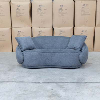 The Noosa Curved Fabric Two Seat Sofa - Dark Grey available to purchase from Warehouse Furniture Clearance at our next sale event.