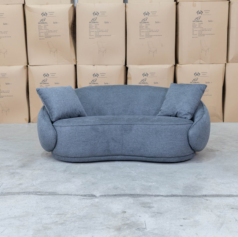 The Noosa Curved Fabric Two Seat Sofa - Dark Grey available to purchase from Warehouse Furniture Clearance at our next sale event.