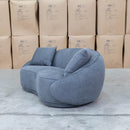 The Noosa Curved Fabric Two Seat Sofa - Dark Grey available to purchase from Warehouse Furniture Clearance at our next sale event.