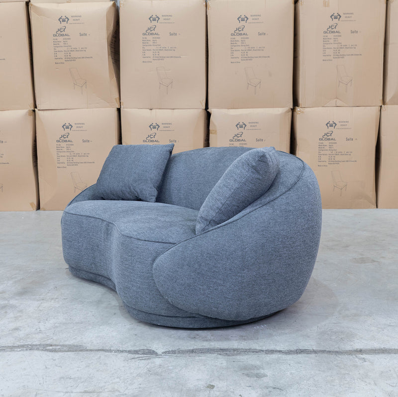 The Noosa Curved Fabric Two Seat Sofa - Dark Grey available to purchase from Warehouse Furniture Clearance at our next sale event.