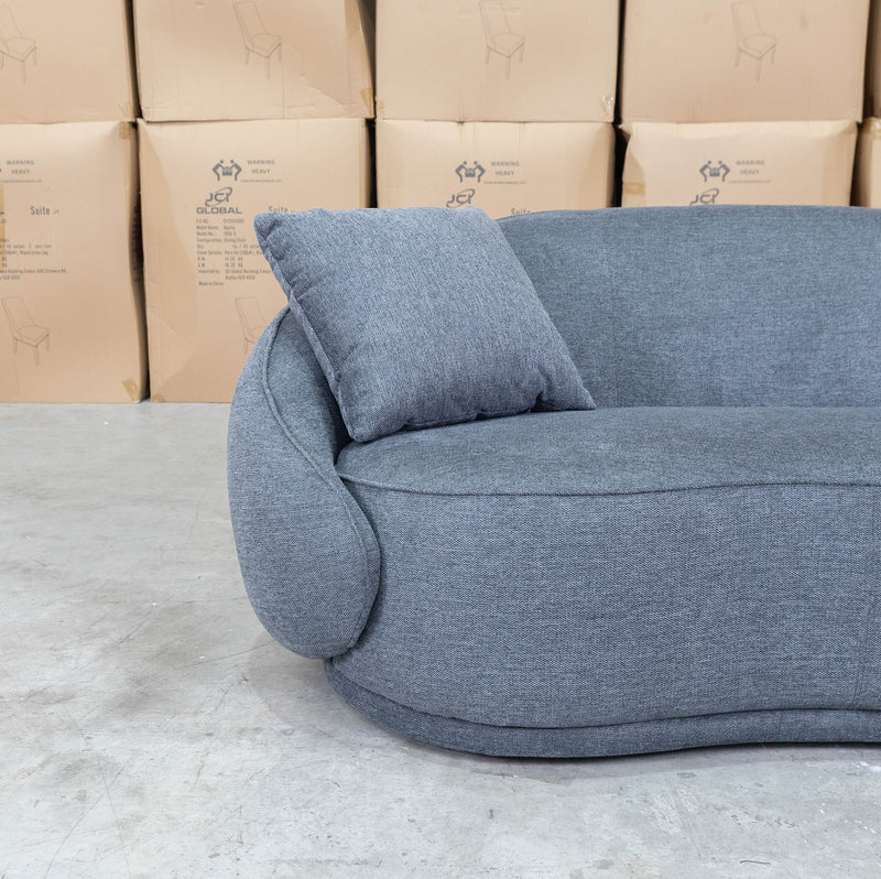 The Noosa Curved Fabric Two Seat Sofa - Dark Grey available to purchase from Warehouse Furniture Clearance at our next sale event.