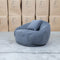 The Noosa Curved Fabric Armchair - Dark Grey available to purchase from Warehouse Furniture Clearance at our next sale event.
