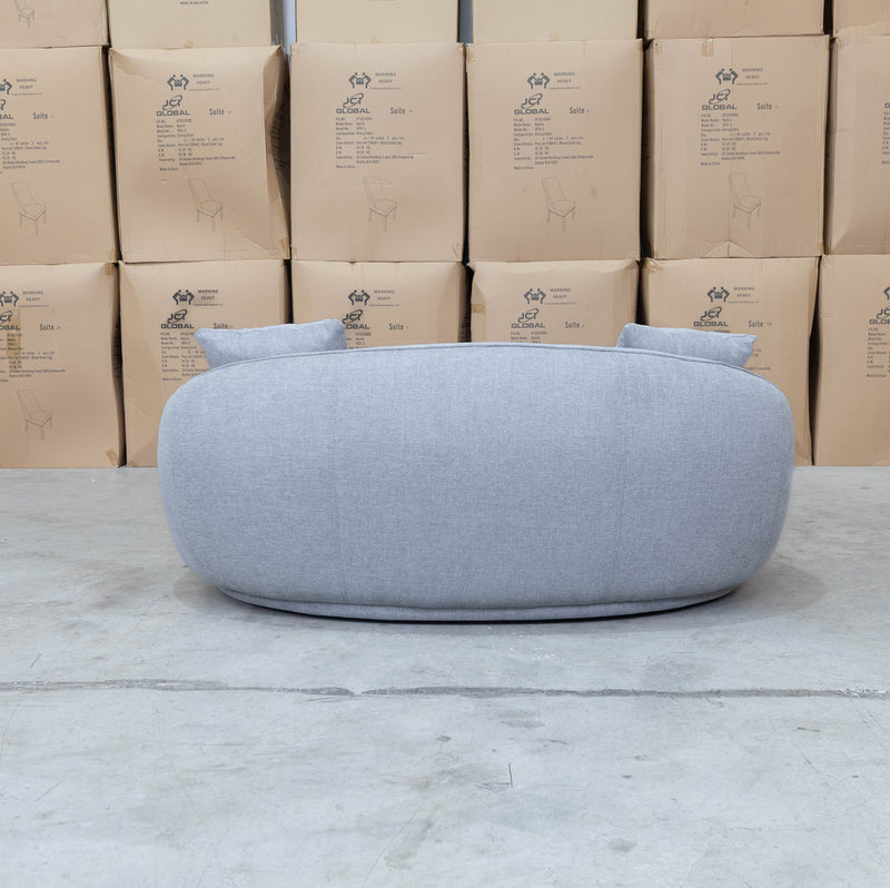 The Noosa Curved Fabric Two Seat Sofa - Light Grey available to purchase from Warehouse Furniture Clearance at our next sale event.