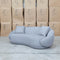 The Noosa Curved Fabric Three Seat Sofa - Light Grey available to purchase from Warehouse Furniture Clearance at our next sale event.