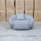 The Noosa Curved Fabric Armchair - Light Grey available to purchase from Warehouse Furniture Clearance at our next sale event.
