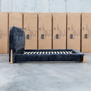 The Okina Queen Upholstered Bed - Black available to purchase from Warehouse Furniture Clearance at our next sale event.