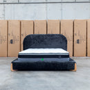 The Okina Queen Upholstered Bed - Black available to purchase from Warehouse Furniture Clearance at our next sale event.