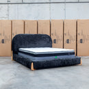 The Okina Queen Upholstered Bed - Black available to purchase from Warehouse Furniture Clearance at our next sale event.