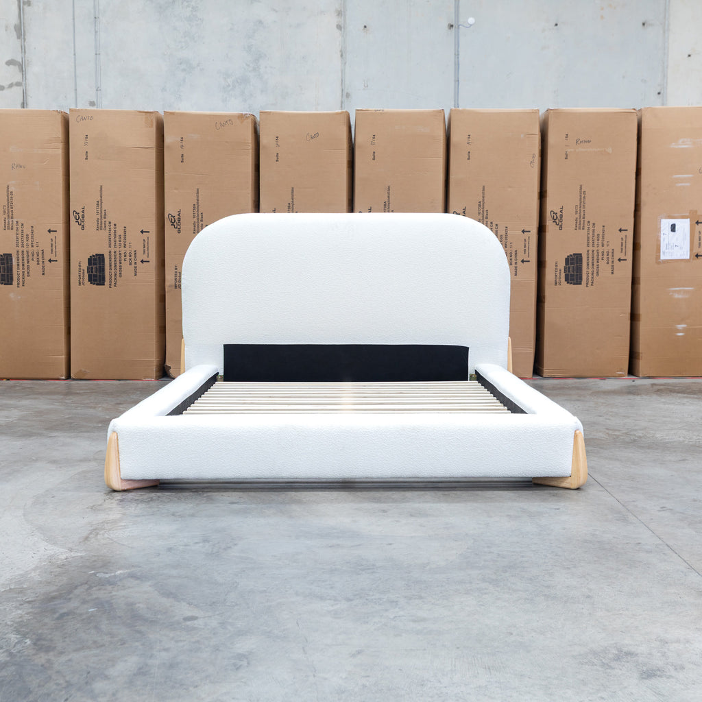 The Okina Queen Upholstered Bed - Cream available to purchase from Warehouse Furniture Clearance at our next sale event.