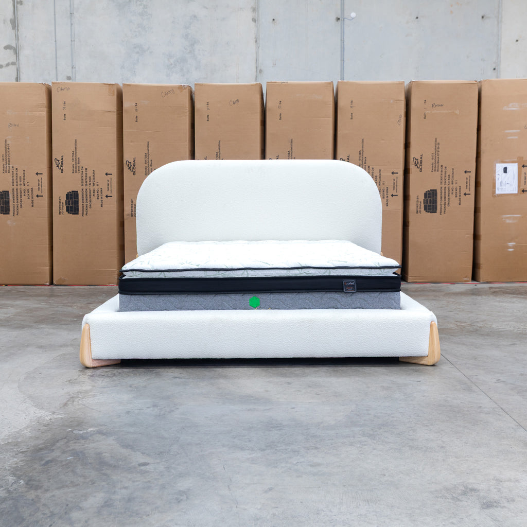 The Okina Queen Upholstered Bed - Cream available to purchase from Warehouse Furniture Clearance at our next sale event.