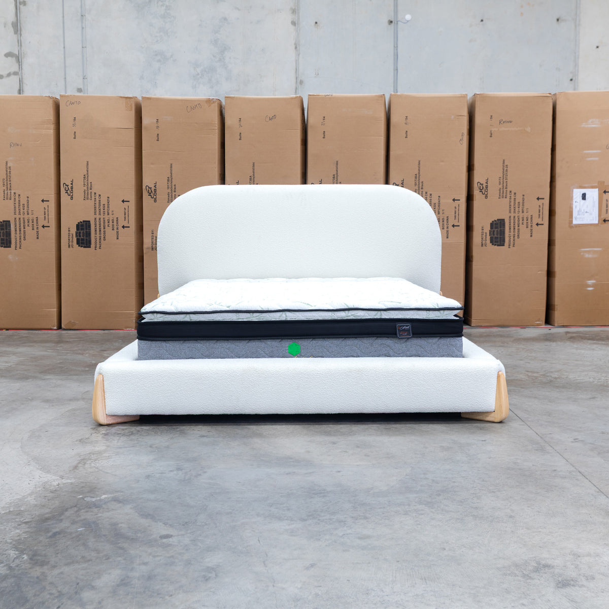 The Okina Queen Upholstered Bed - Cream available to purchase from Warehouse Furniture Clearance at our next sale event.