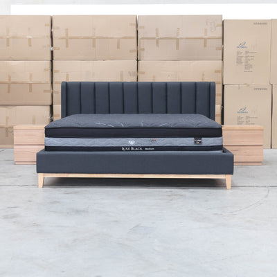 The Paros King Upholstered Bed - Charcoal available to purchase from Warehouse Furniture Clearance at our next sale event.