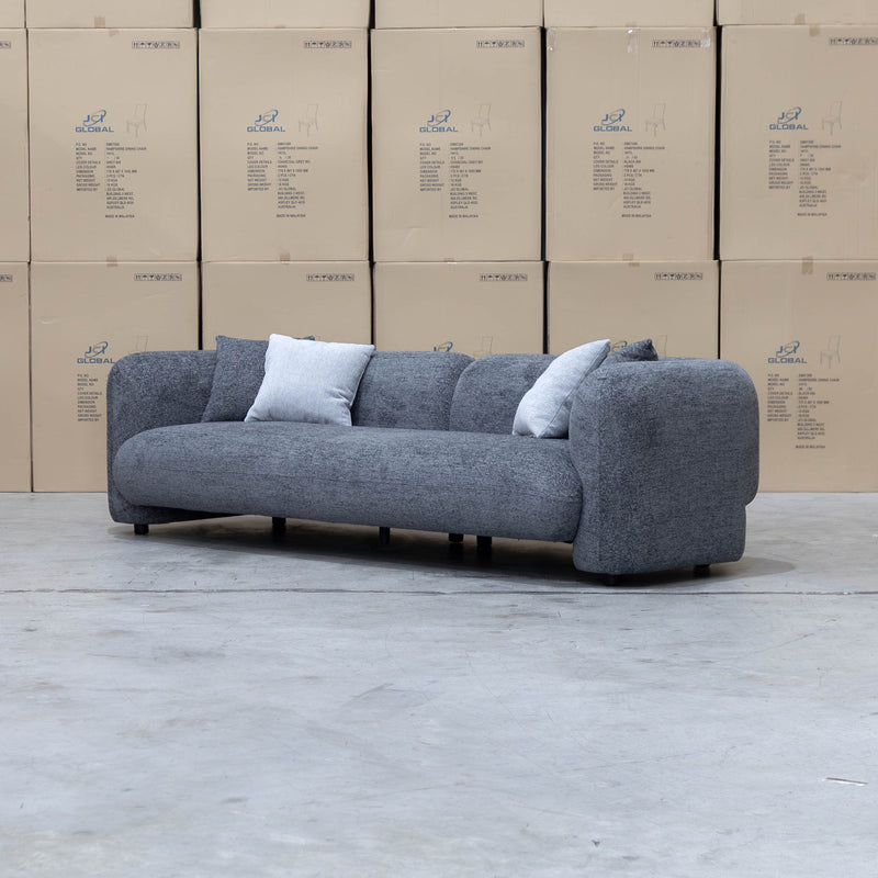 The Raven Curved Four Seat Sofa - Charcoal available to purchase from Warehouse Furniture Clearance at our next sale event.