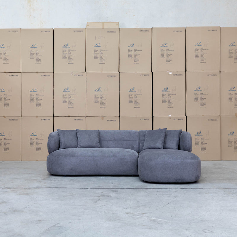 The Rhodes Curved Three Seat Chaise Lounge - Charcoal available to purchase from Warehouse Furniture Clearance at our next sale event.