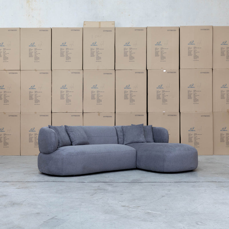 The Rhodes Curved Three Seat Chaise Lounge - Charcoal available to purchase from Warehouse Furniture Clearance at our next sale event.