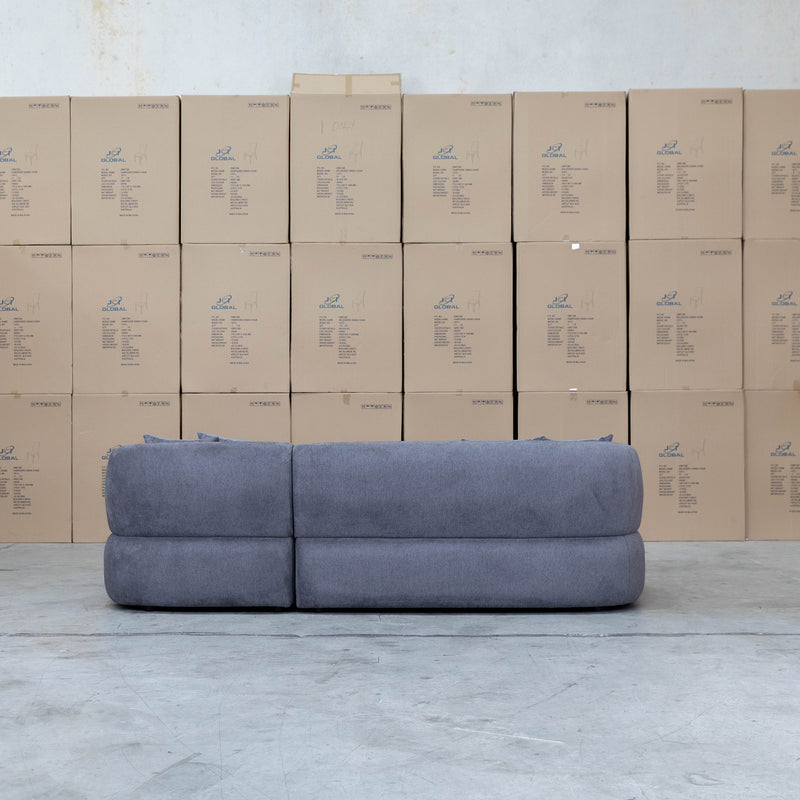 The Rhodes Curved Three Seat Chaise Lounge - Charcoal available to purchase from Warehouse Furniture Clearance at our next sale event.