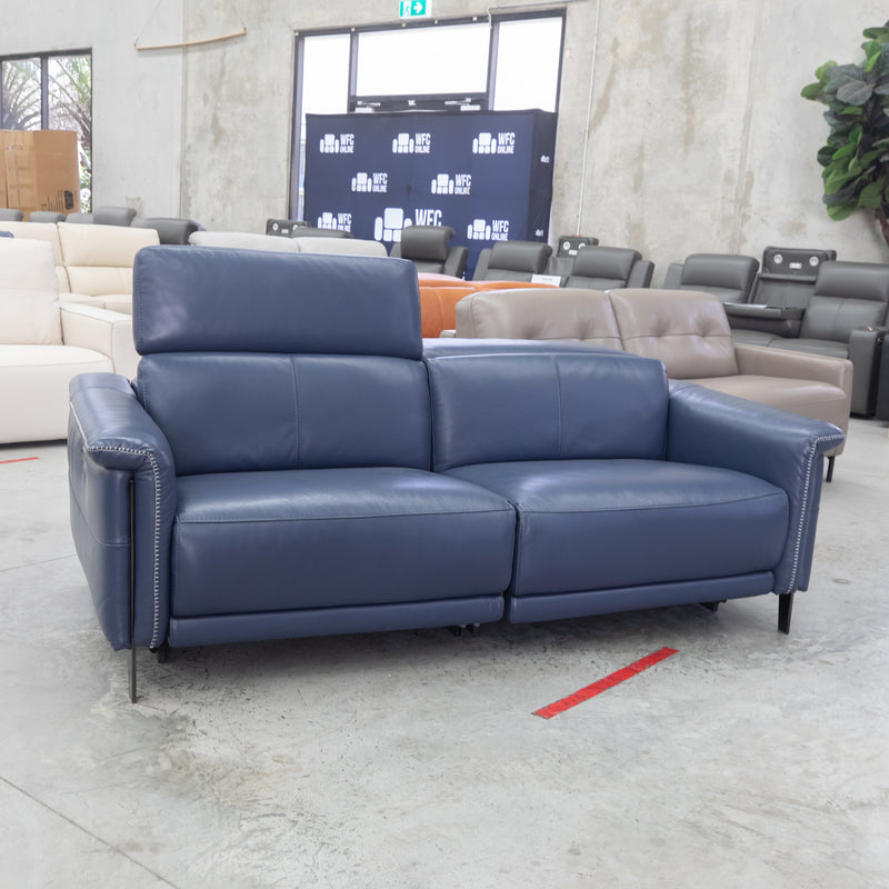 The Samantha Electric Dual Motor 2 Seat Sofa - Blue Leather - Floor Stock As Is available to purchase from Warehouse Furniture Clearance at our next sale event.