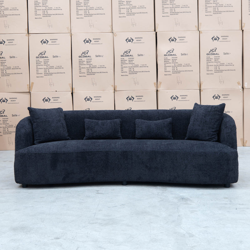 The Santorini Curved Three Seat Sofa - Boucle Black available to purchase from Warehouse Furniture Clearance at our next sale event.