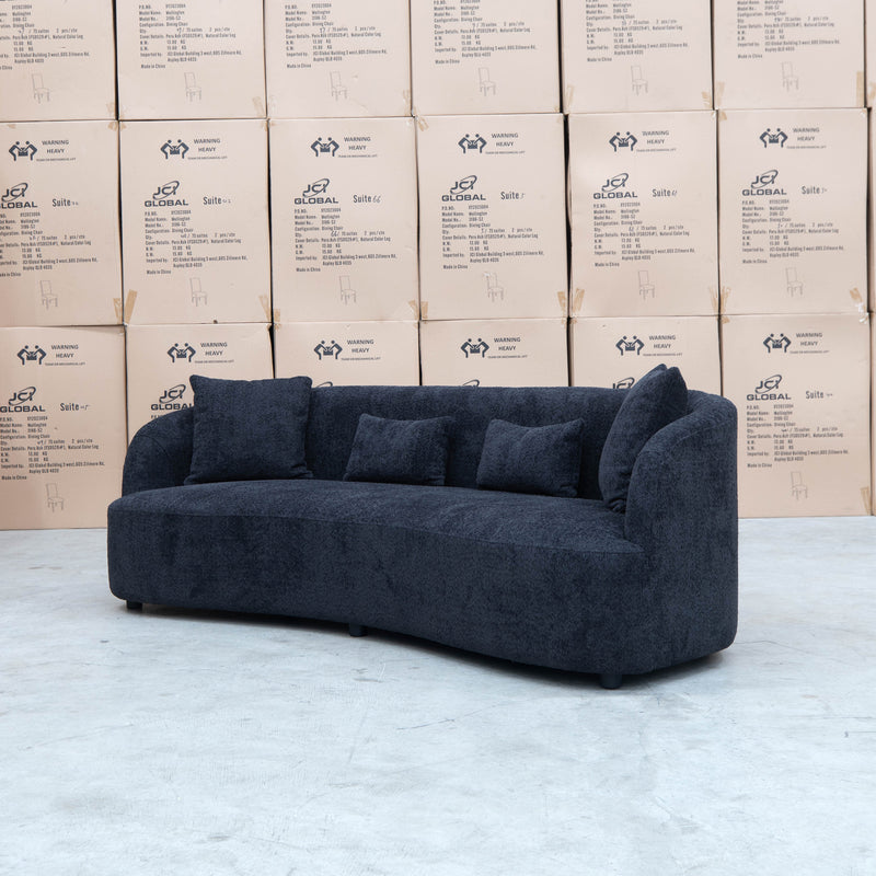 The Santorini Curved Three Seat Sofa - Boucle Black available to purchase from Warehouse Furniture Clearance at our next sale event.