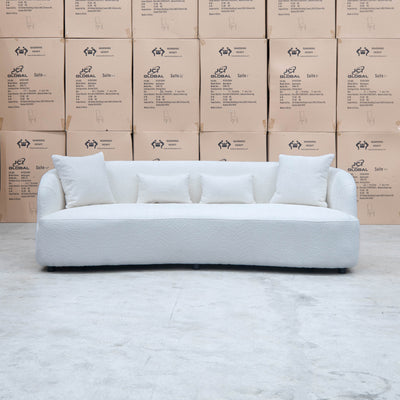The Santorini Curved Three Seat Sofa - Boucle Ivory available to purchase from Warehouse Furniture Clearance at our next sale event.