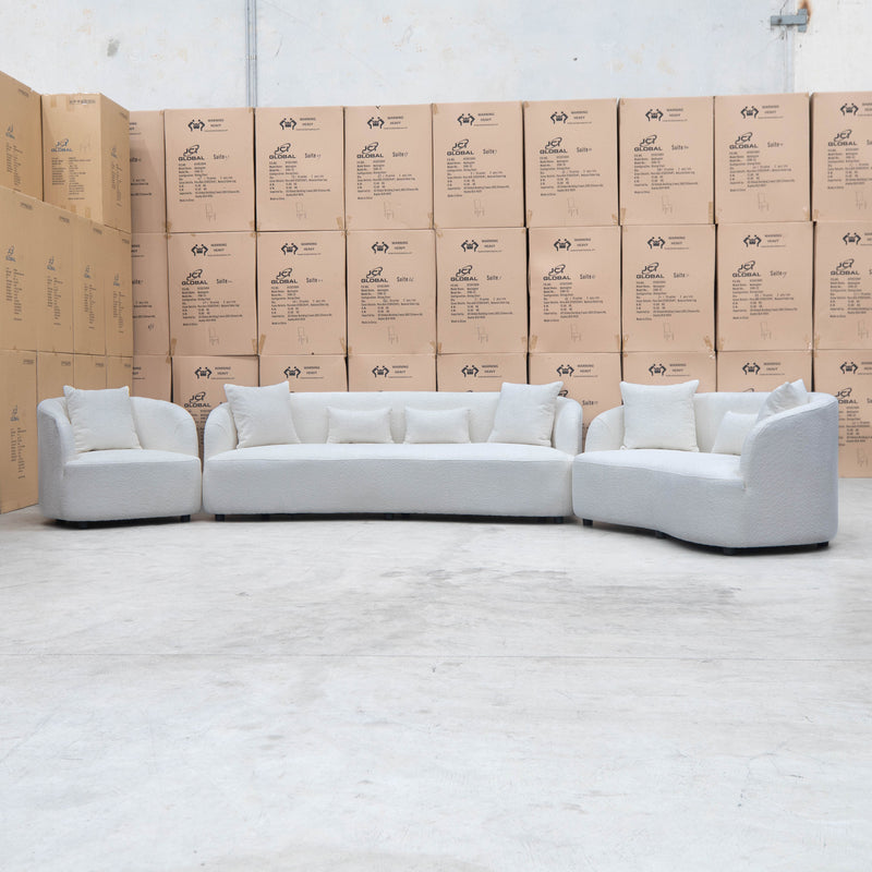 The Santorini Curved Three Seat Sofa - Boucle Ivory - Available After 12th November available to purchase from Warehouse Furniture Clearance at our next sale event.