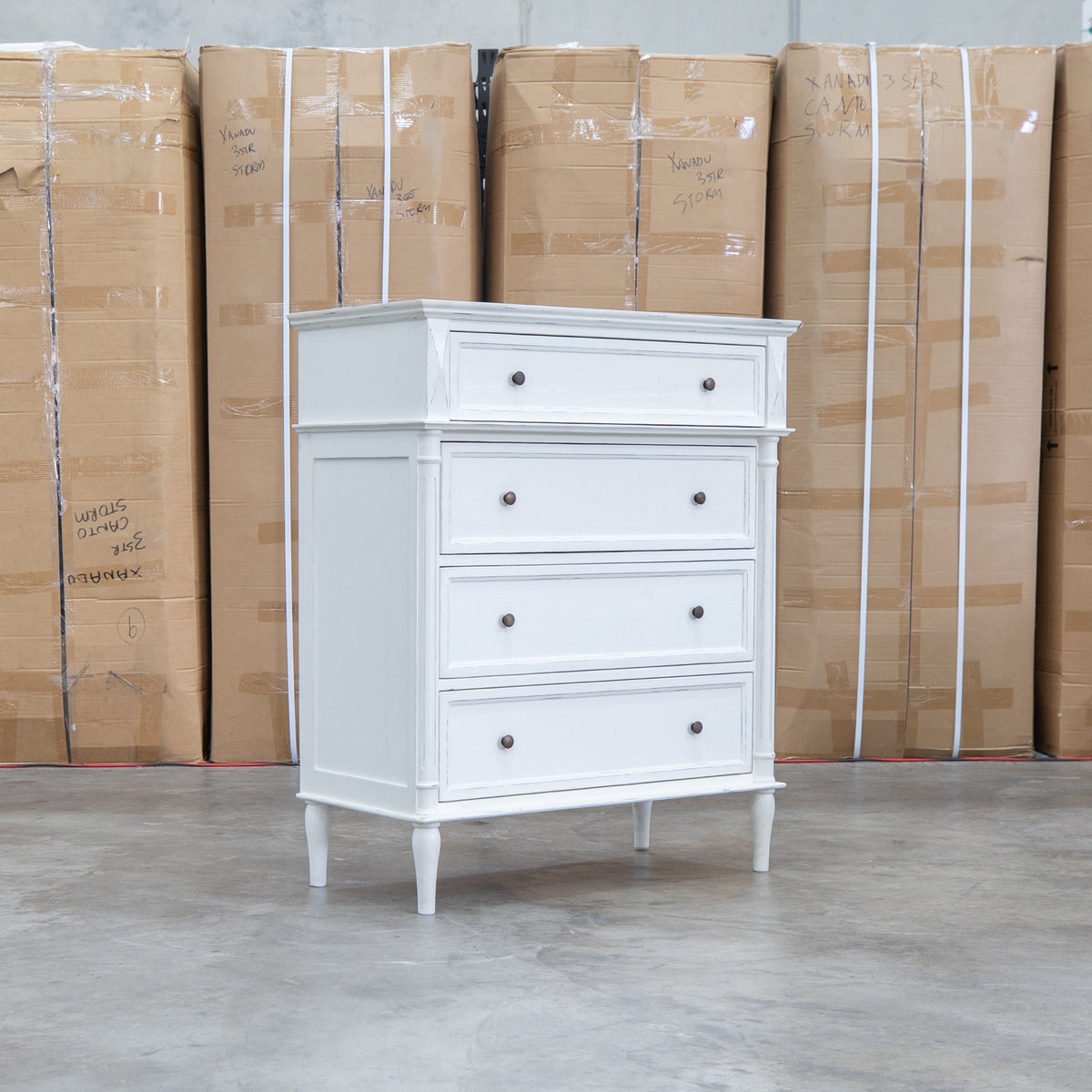 The Bruges Antique White Four Drawer Tallboy available to purchase from Warehouse Furniture Clearance at our next sale event.
