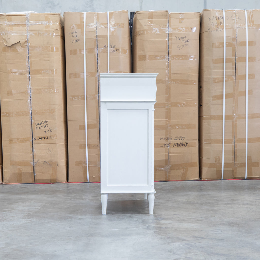 The Bruges Antique White Four Drawer Tallboy available to purchase from Warehouse Furniture Clearance at our next sale event.