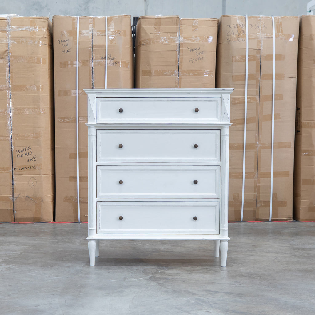The Bruges Antique White Four Drawer Tallboy available to purchase from Warehouse Furniture Clearance at our next sale event.