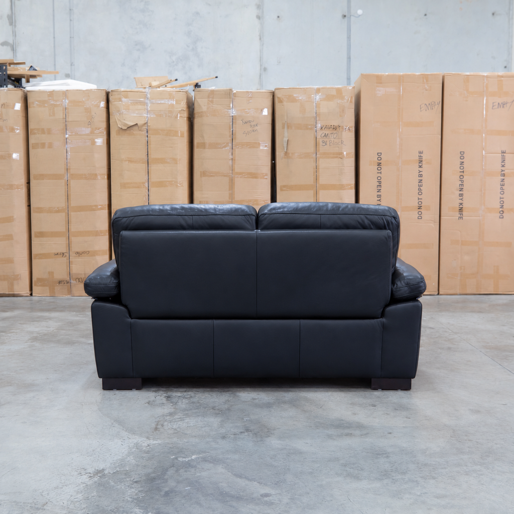 The Tayla Leather Two Seat Sofa - Black available to purchase from Warehouse Furniture Clearance at our next sale event.
