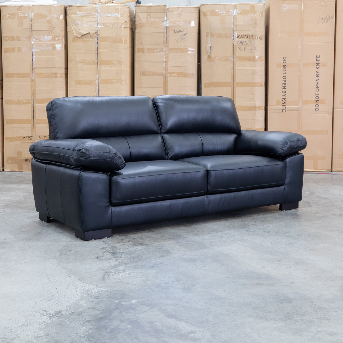 The Tayla Leather Three Seat Sofa - Black available to purchase from Warehouse Furniture Clearance at our next sale event.