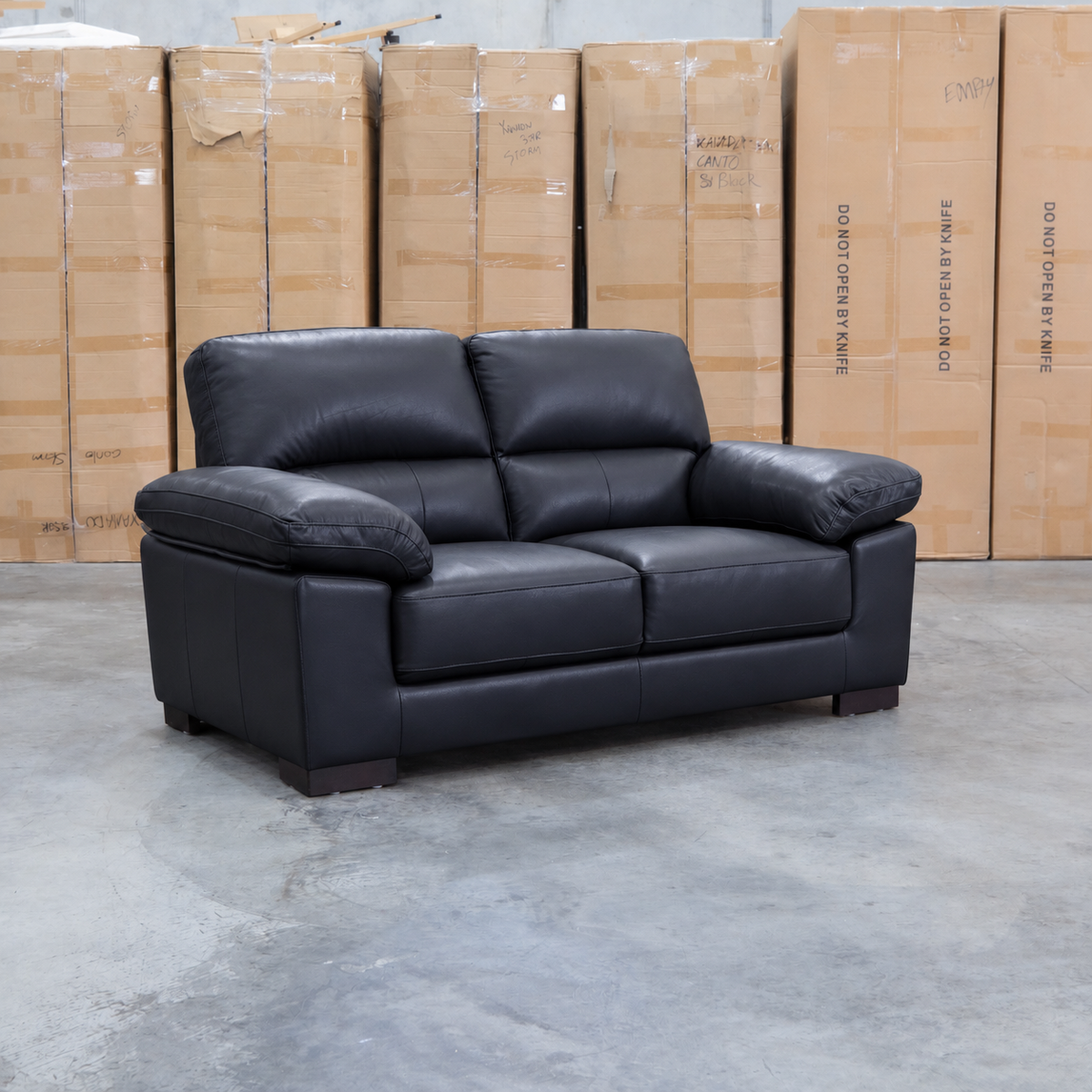 The Tayla Leather Two Seat Sofa - Black available to purchase from Warehouse Furniture Clearance at our next sale event.