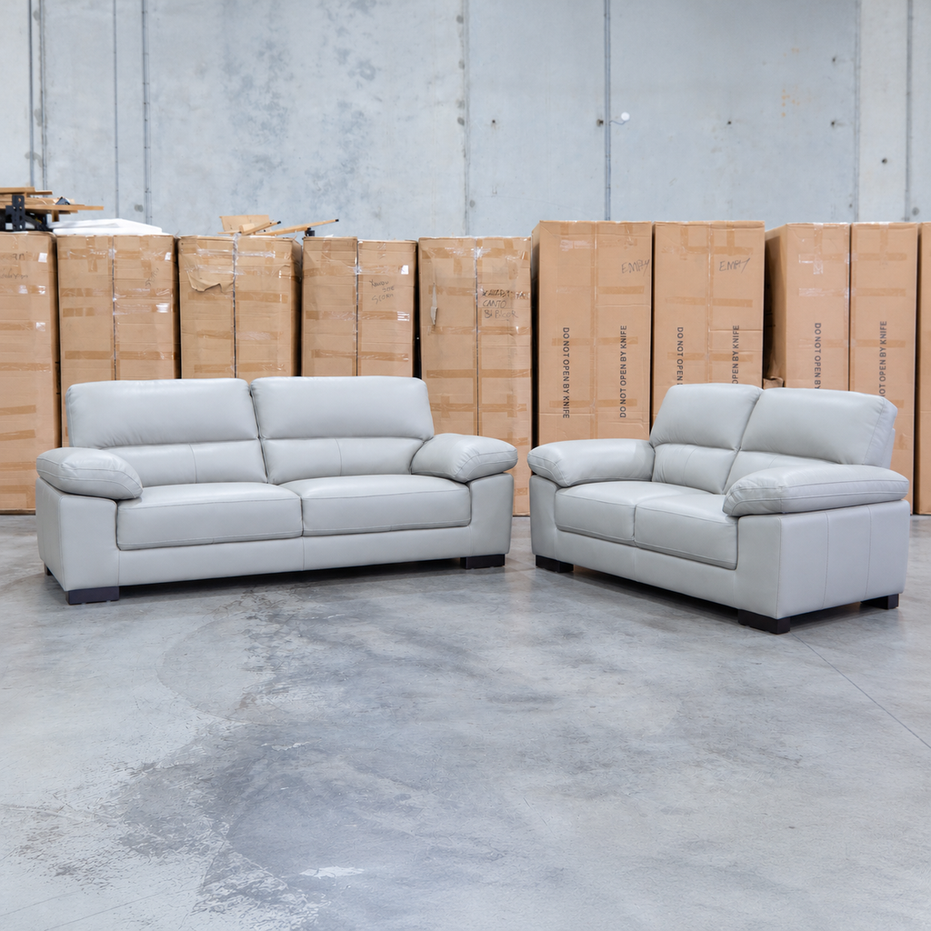 The Tayla Leather Three Seat Sofa - Light Grey available to purchase from Warehouse Furniture Clearance at our next sale event.