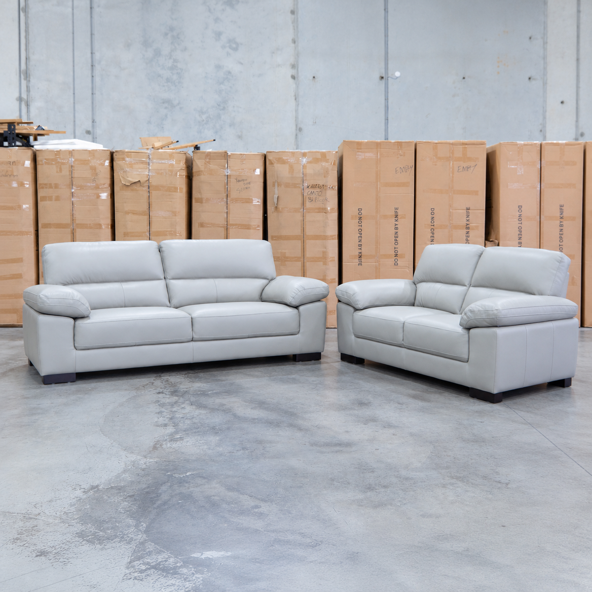 The Tayla Leather Three Seat Sofa - Light Grey available to purchase from Warehouse Furniture Clearance at our next sale event.