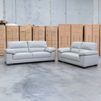 The Tayla Leather Two Seat Sofa - Light Grey available to purchase from Warehouse Furniture Clearance at our next sale event.