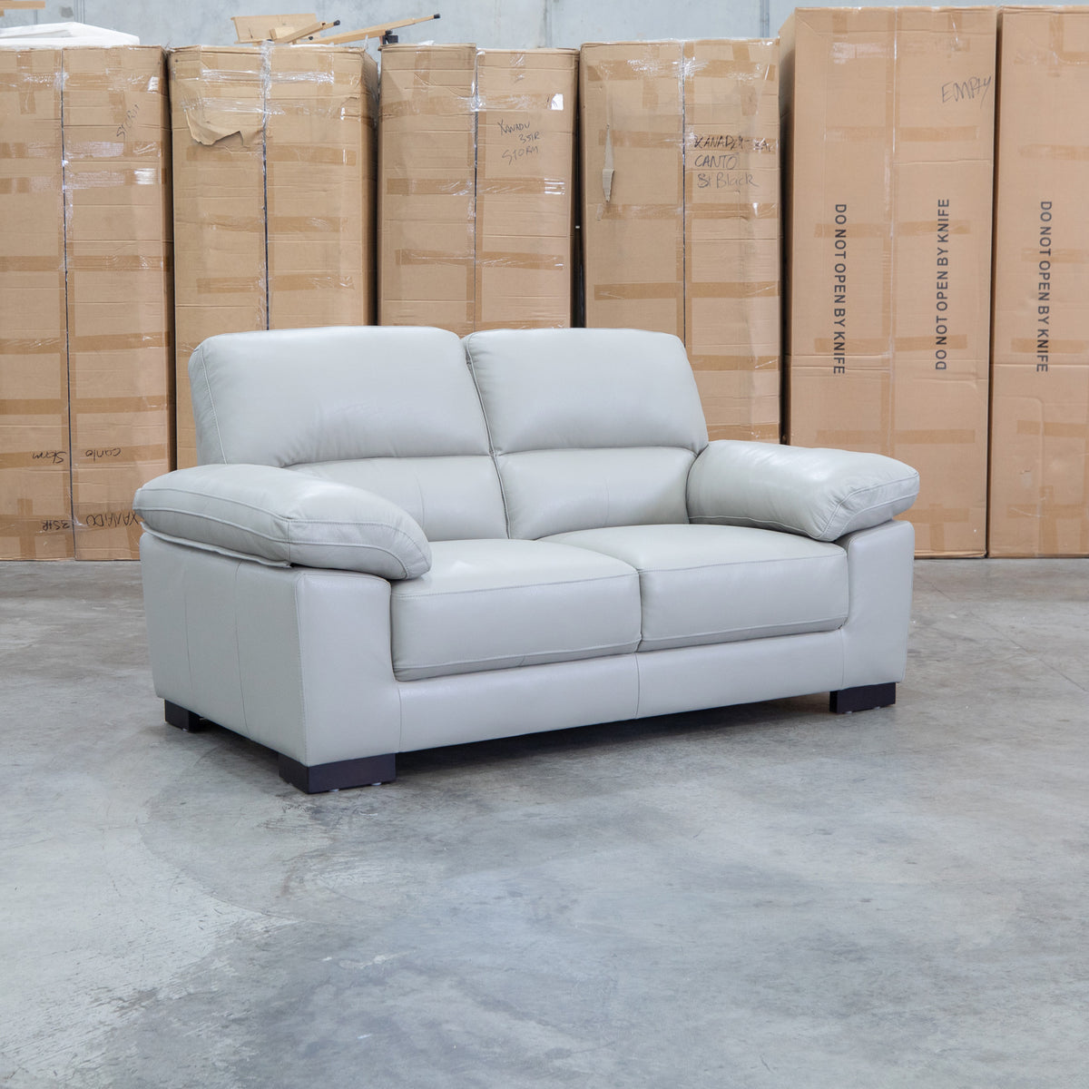 The Tayla Leather Two Seat Sofa - Light Grey available to purchase from Warehouse Furniture Clearance at our next sale event.