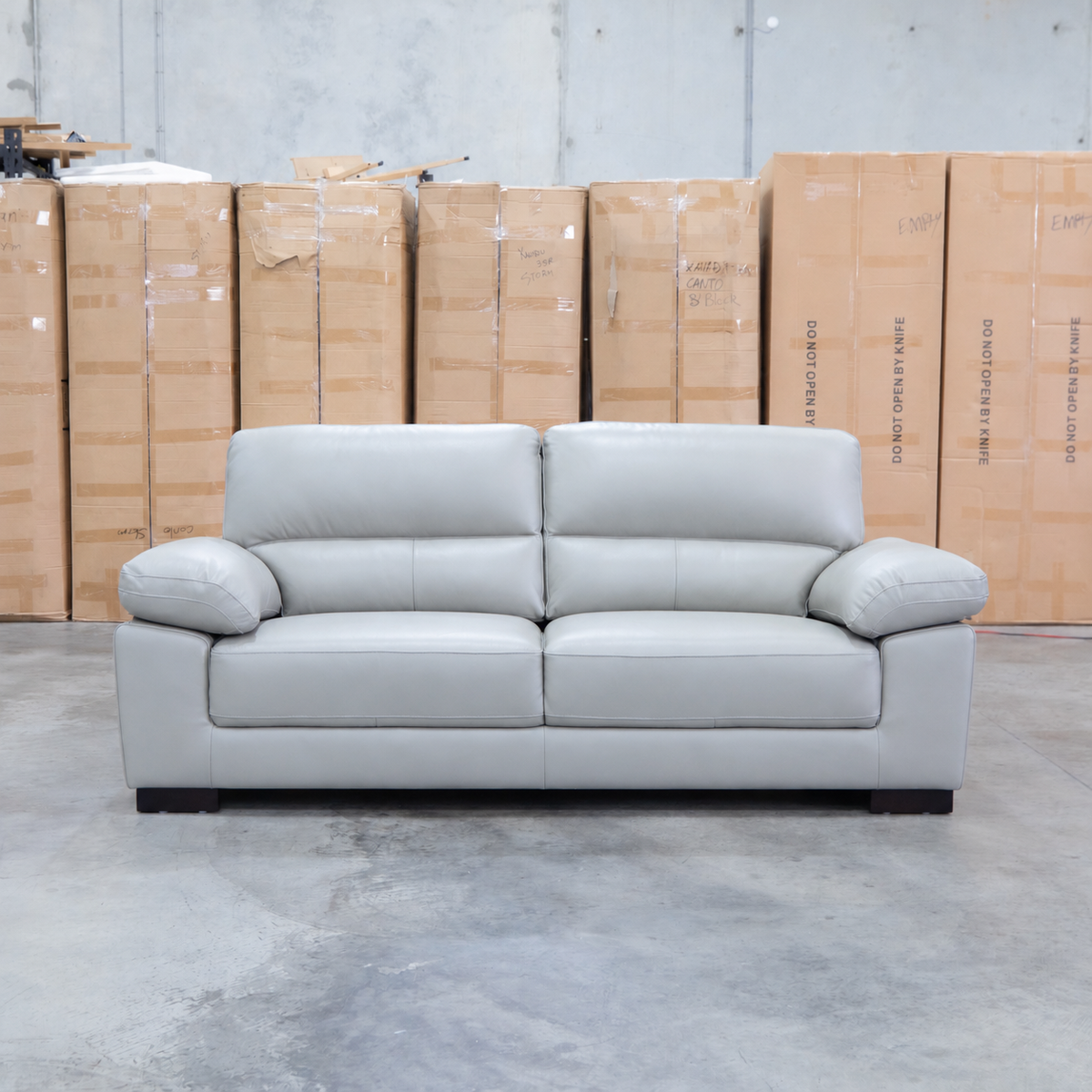 The Tayla Leather Three Seat Sofa - Light Grey available to purchase from Warehouse Furniture Clearance at our next sale event.