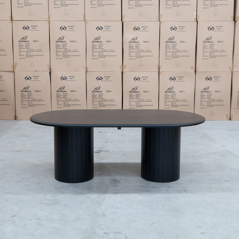 The Semillon 210cm New Zealand Ash Oval Dining Table - Black available to purchase from Warehouse Furniture Clearance at our next sale event.