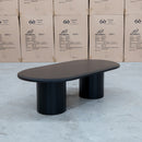 The Semillon New Zealand Ash Oval Coffee Table - Black available to purchase from Warehouse Furniture Clearance at our next sale event.