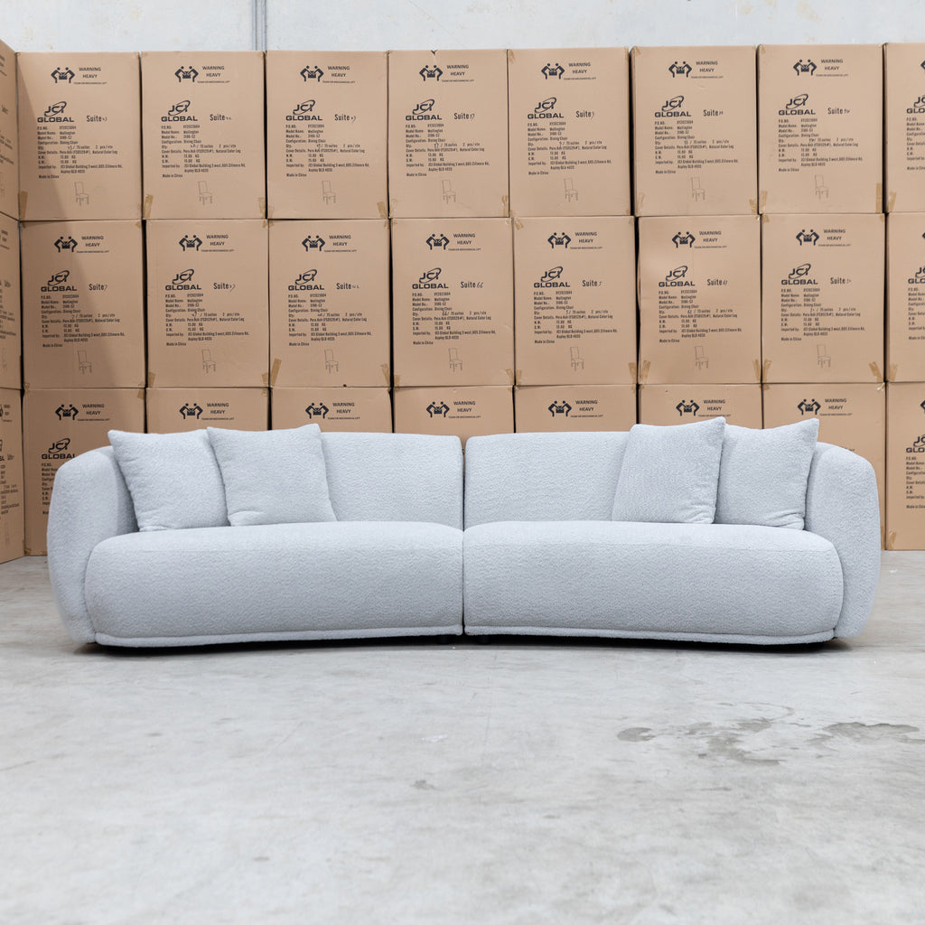 The Trenton Curved Boucle Four Seater - Light Grey available to purchase from Warehouse Furniture Clearance at our next sale event.